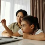 uttarakhand tour Mother and daughter engaged in online learning at home, using a laptop.